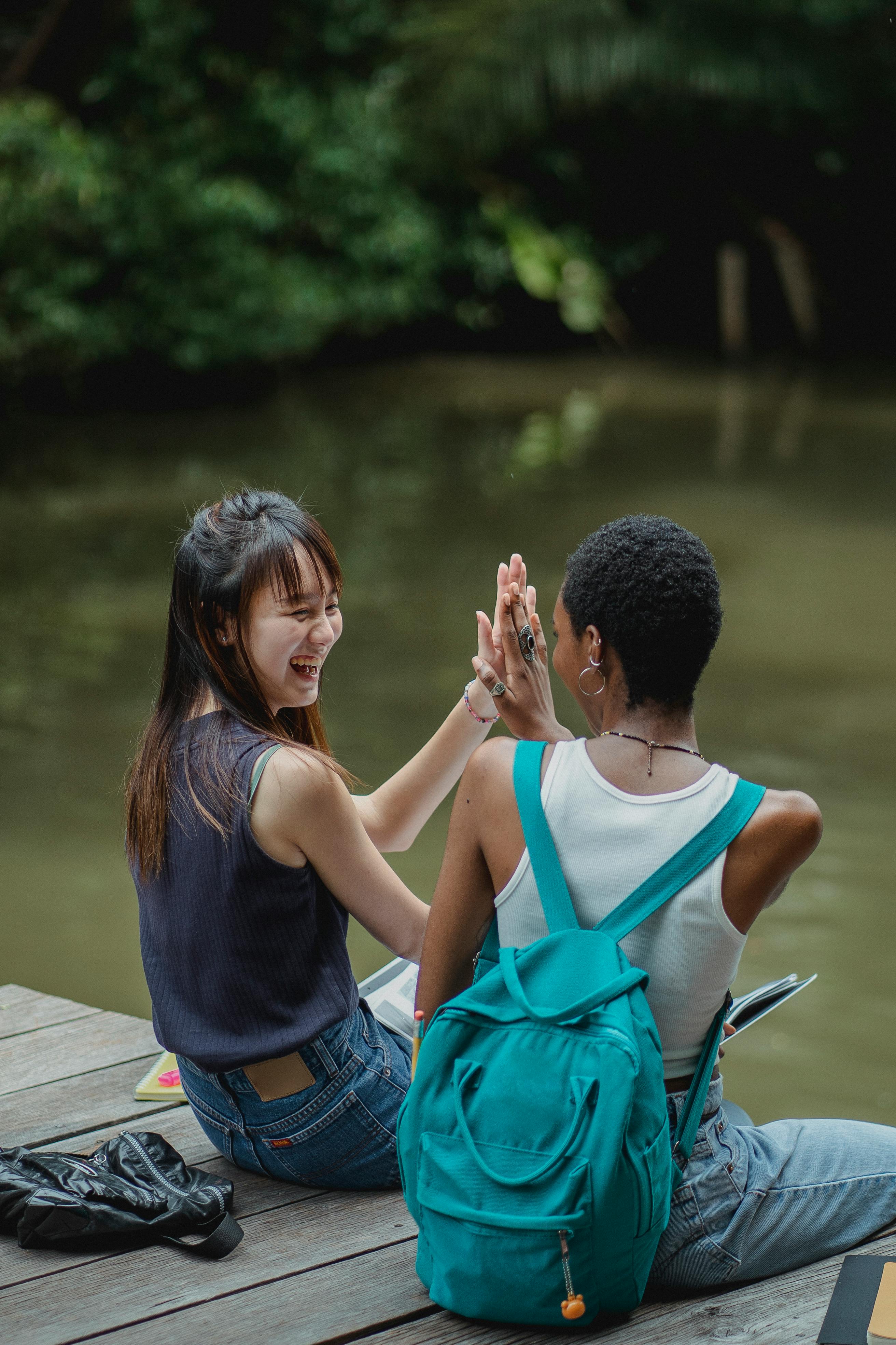 cheerful women giving each other high five