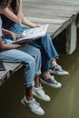 Friends reading book on bridge
