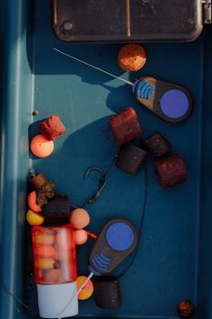 Top view of colorful fishing baits and gear in a tackle box, perfect for angling enthusiasts.