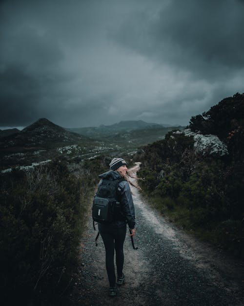 A Woman Walking on the Pathway