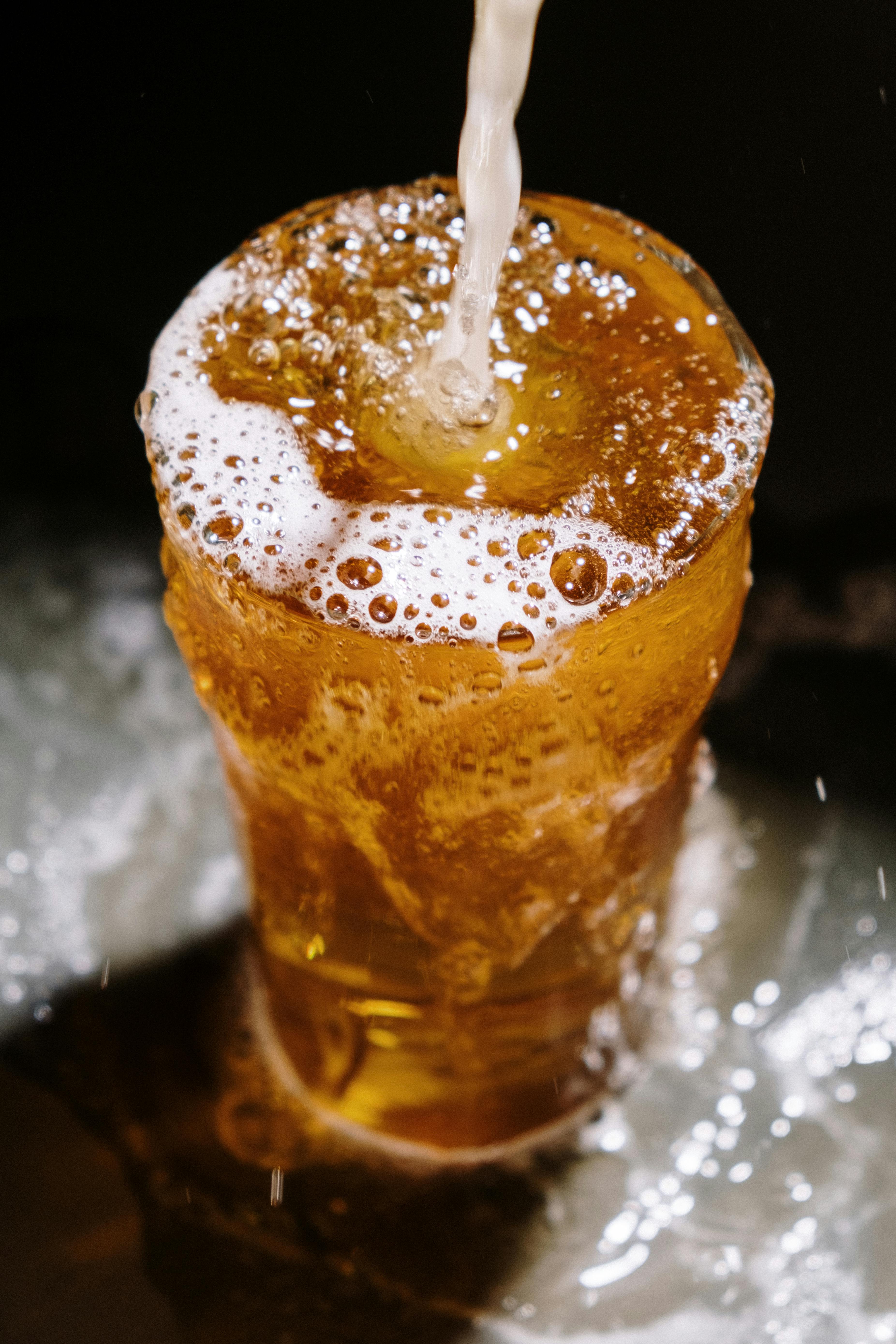 a clear drinking glass with beer