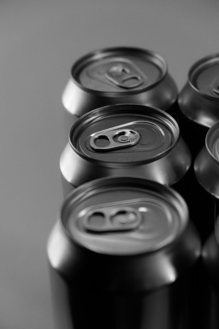 Grayscale Photo Of Cans