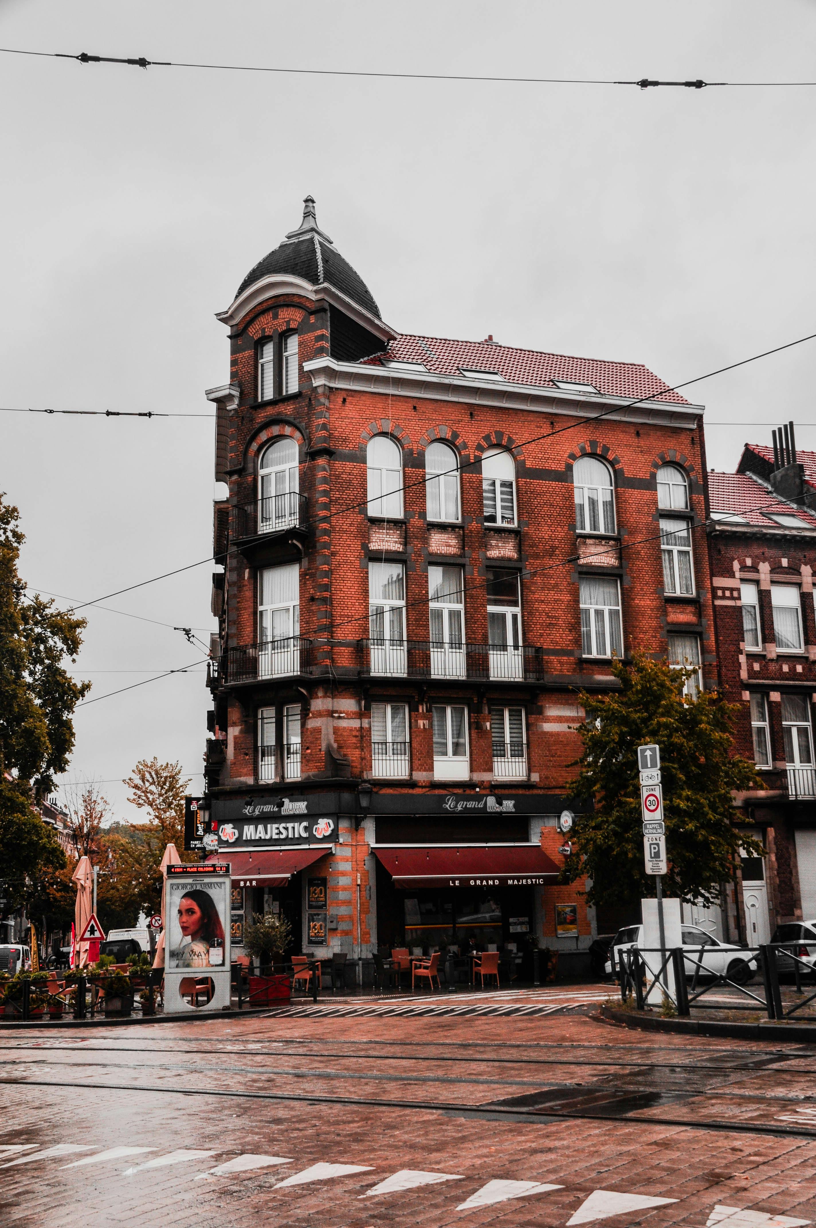 Free A vintage brick building in Schaerbeek, Brussels on a rainy day, capturing local urban charm. Stock Photo
