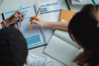 Unrecognizable female students studying with books