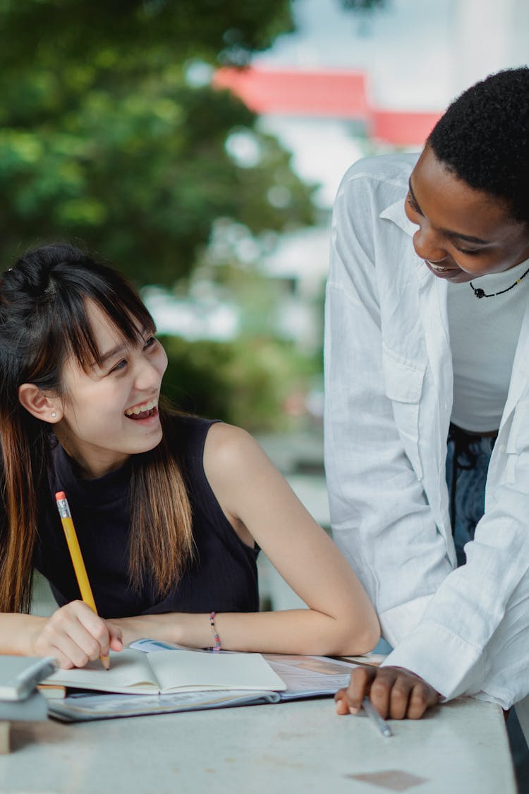 Multiracial Female Friends Preparing For Exam Outside