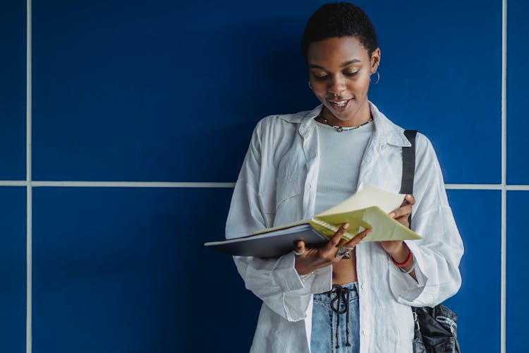 African American Woman Standing With Notebook