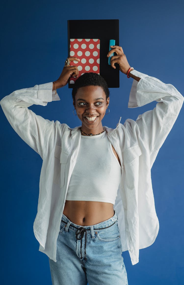 Happy Black Woman Standing With Notebook And Marker