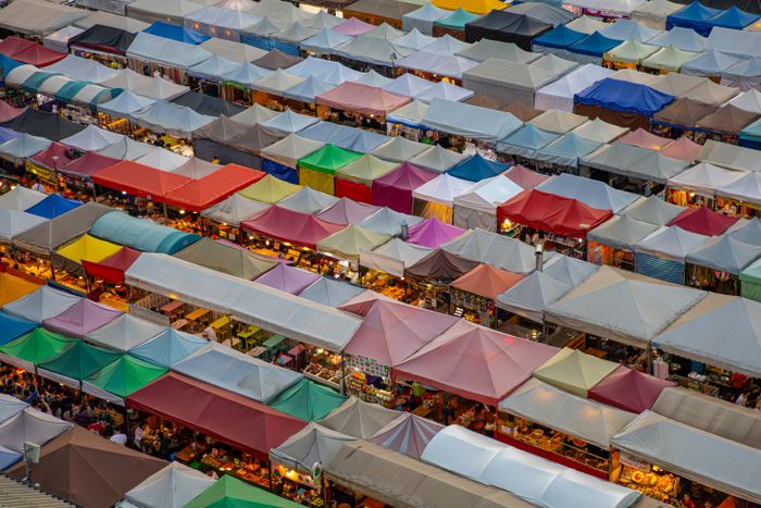 Aerial view of colourful market stalls arranged in rows