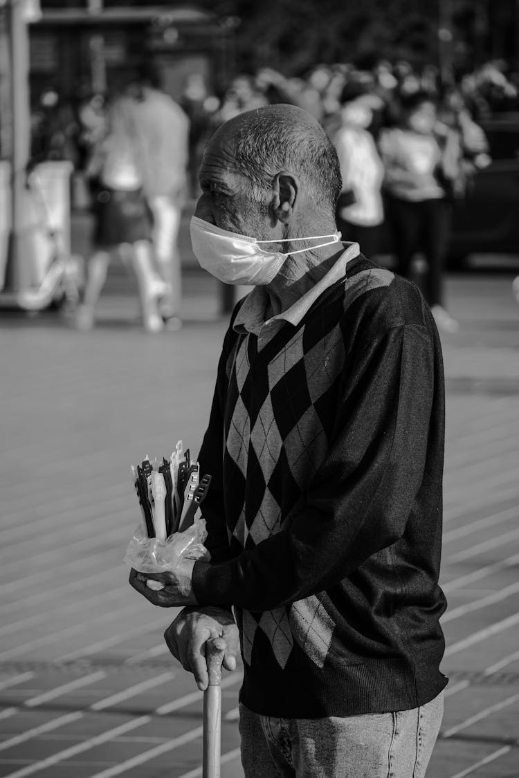 Grayscale Photo Of An Elderly Man Wearing A Face Mask