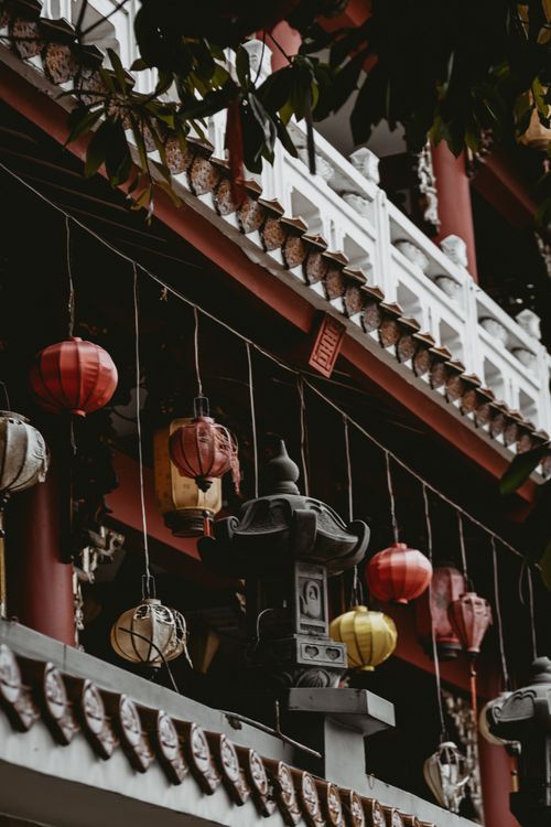 Free Ornate lanterns adorn a traditional Vietnamese temple balcony in Ho Chi Minh City, exuding cultural richness. Stock Photo