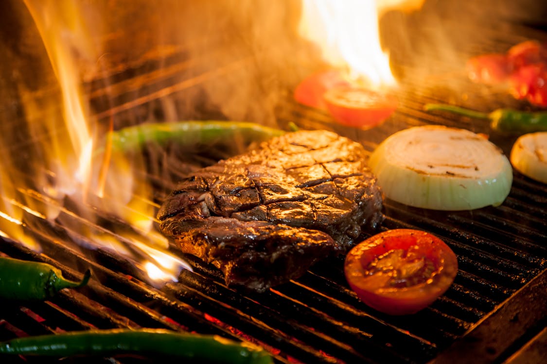 Free Grilled Meat on Charcoal Grill Stock Photo