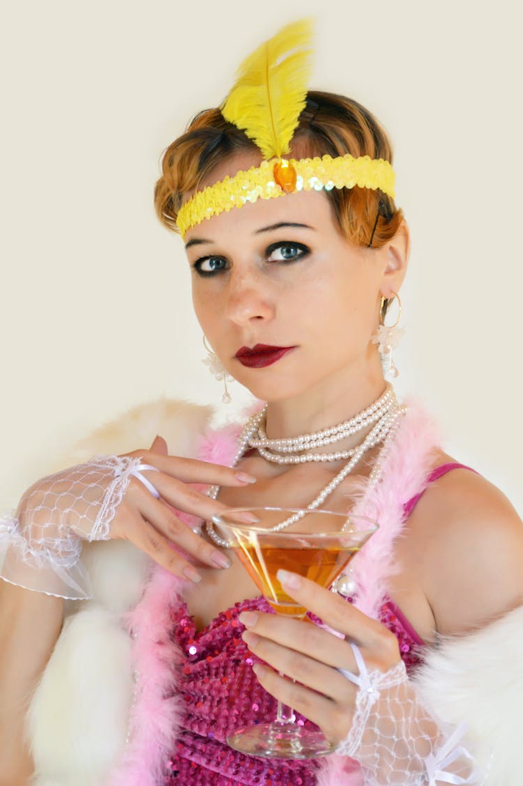 Woman In Stylish Wear With Cocktail On Light Background