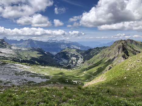 Breathtaking view of mountains and valleys in Furna, Switzerland with a partly cloudy sky.