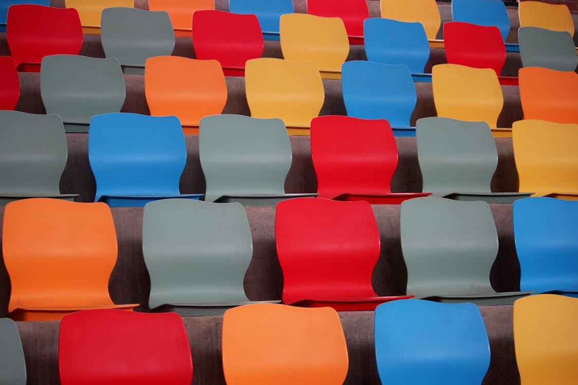 Free Empty Rows of Colorful Seats Stock Photo