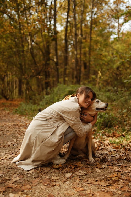 Woman Sitting While Hugging her Dog 