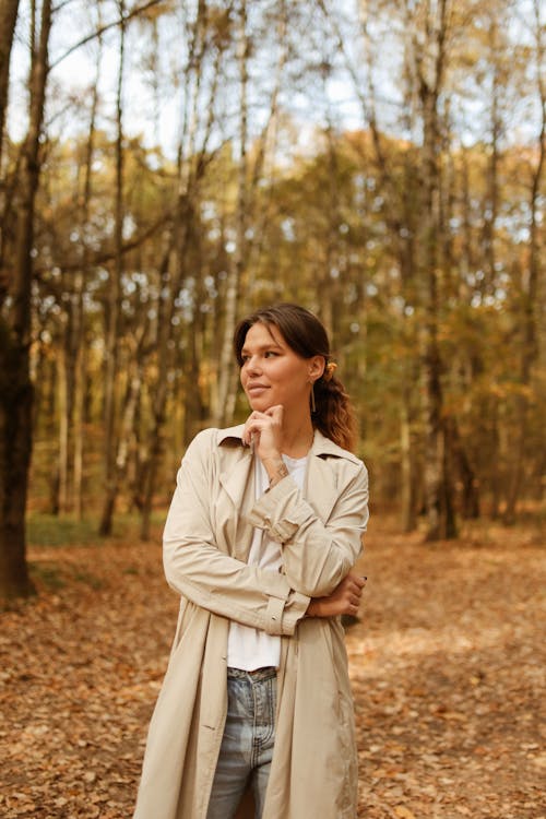 Shallow Focus of Woman in Beige Trench Coat Looking to Her Right