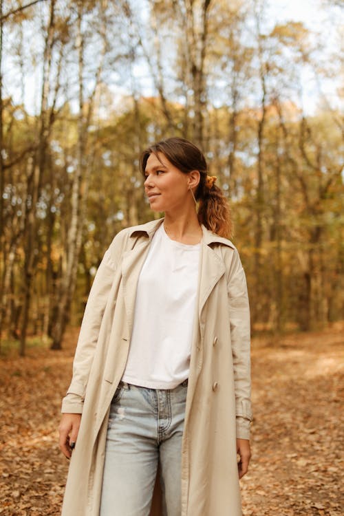 Shallow Focus of Woman in Beige Trench Coat Looking to Her Right