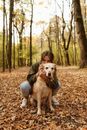 A Woman Hugging her Labrador Retriever Dog From the Back