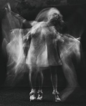 Artistic long exposure of a blurred ballerina creating a ghostly effect in motion.