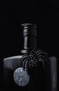 Black Alcohol Bottle with Spider Charm Atta
