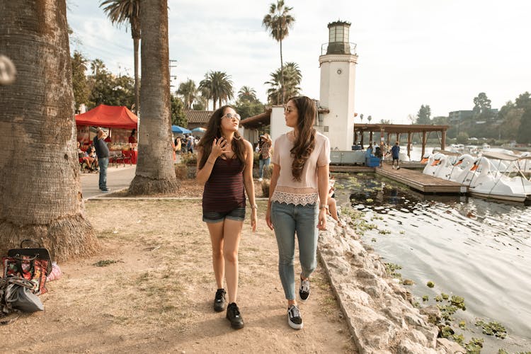 Women Walking And Talking Near A Lake