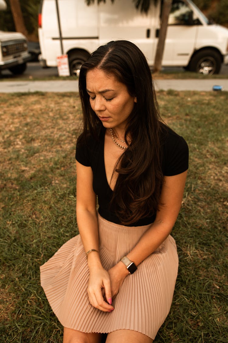 
A Melancholic Woman Wearing A Black Shirt And A Skirt