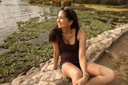 Smiling Woman Relaxing By a Lake