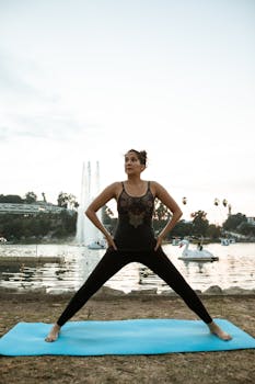 Serene lakeside yoga session by a mature woman in the evening, achieving inner peace.