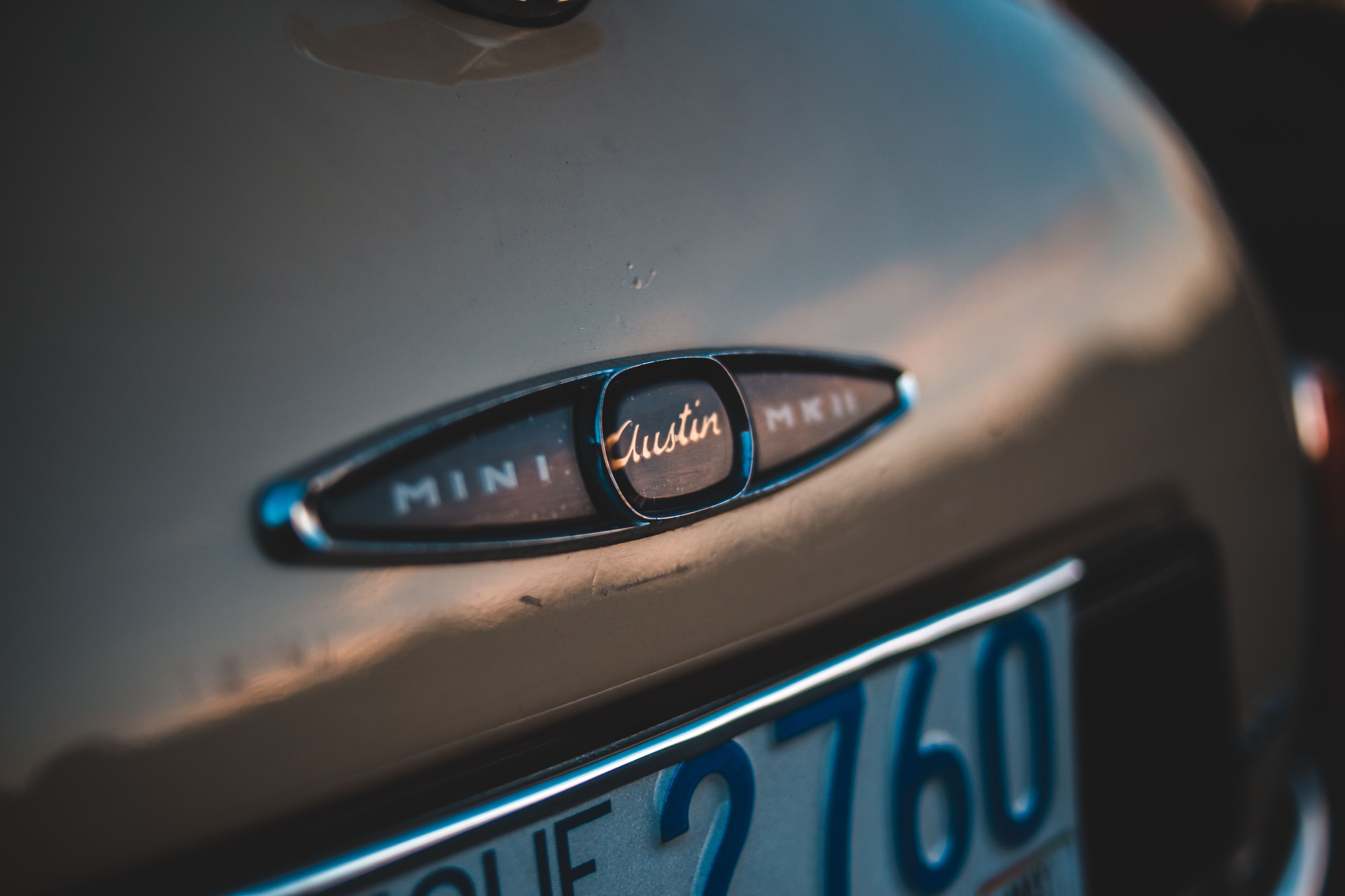 Fragment of expensive vintage car with stylish emblem on boot placed on street