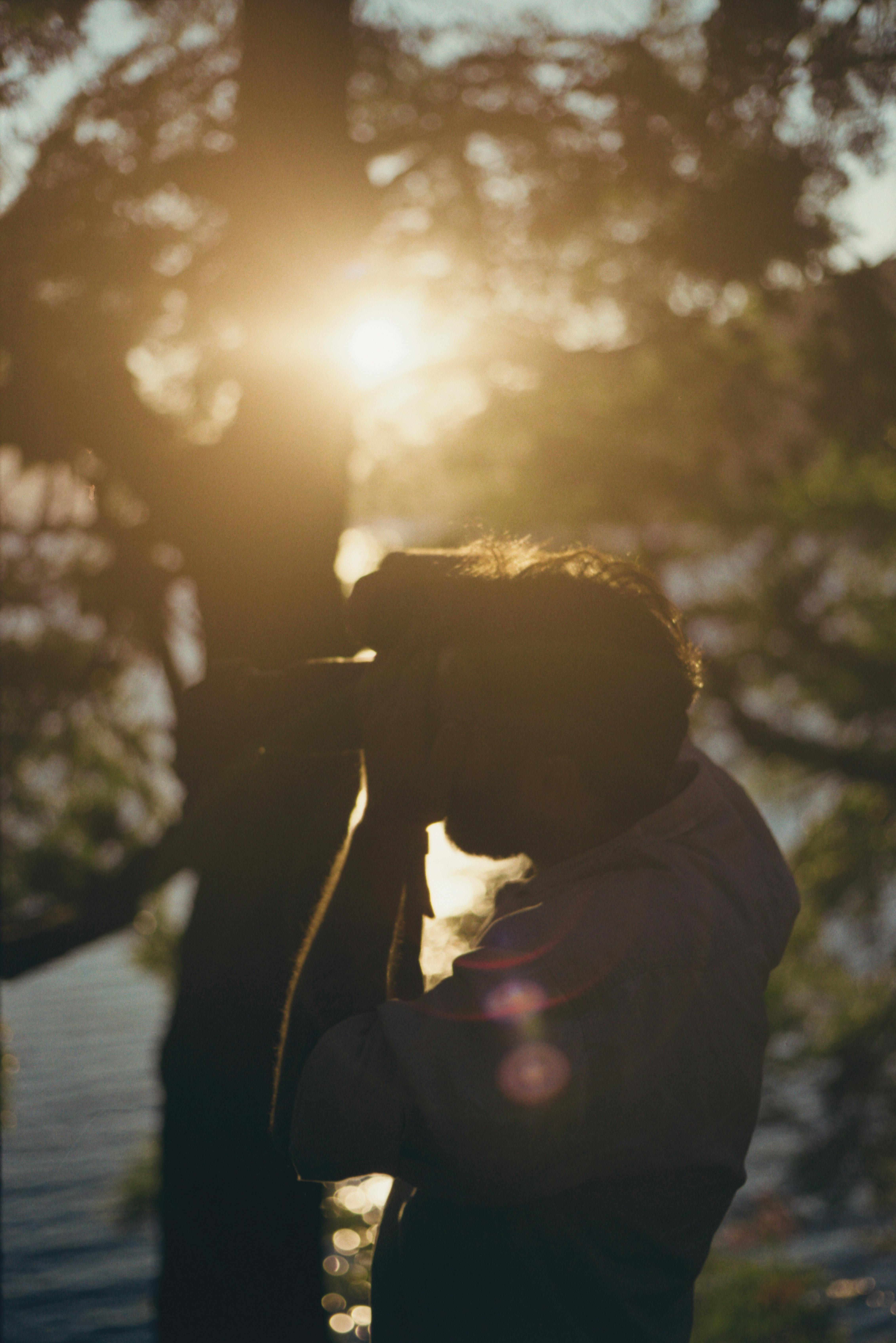 Silhouette of a photographer capturing the sunset by a lake in Argentina.
