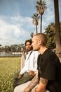 Man in Black Jacket Sitting Beside Man in White Dress Shirt