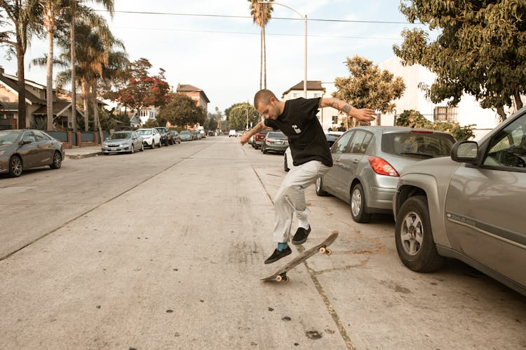 A Man Skateboarding In The Street