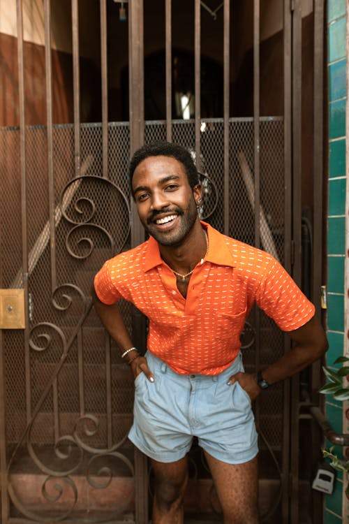 Man in Orange Polo Shirt Free Stock Photo