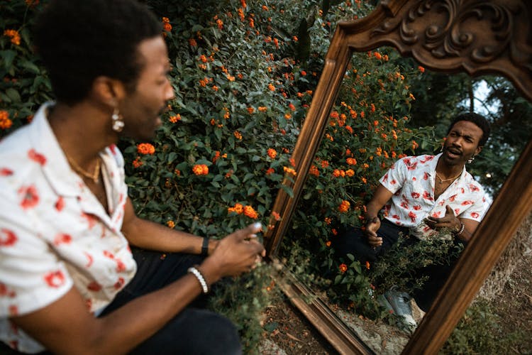 A Man Talking To Himself In The Mirror