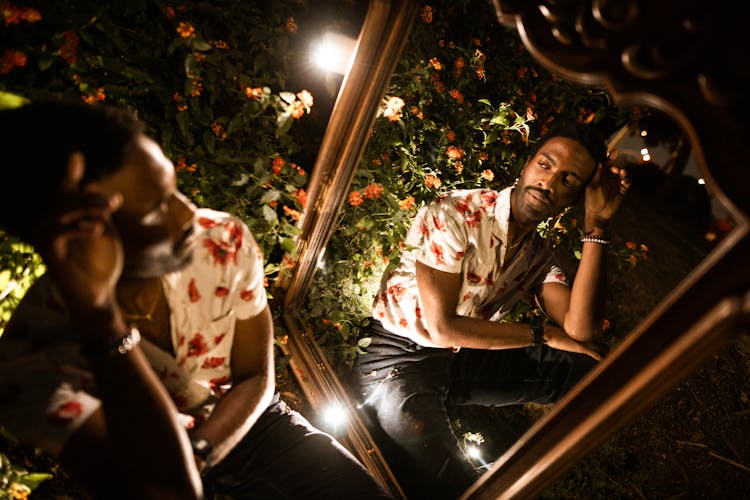 A Man Posing In Front Of A Mirror