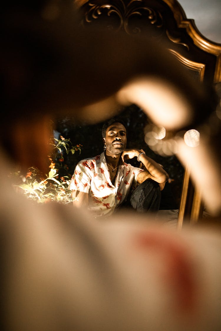 A Reflection Of A Man Posing In Front Of A Mirror