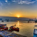 Boats Docked on a Pier During Sunset