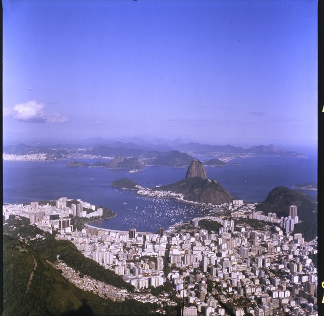 Best Samba Helicopter Tour: Private Flight - 4 People Review Review 2026 - Breathtaking aerial view of Rio de Janeiro with Sugarloaf Mountain and Guanabara Bay under a clear blue sky.