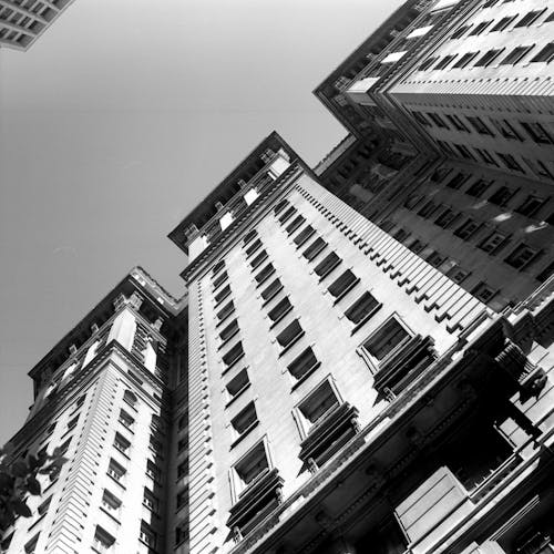 Black and white perspective of tall building facade in old center of megapolis