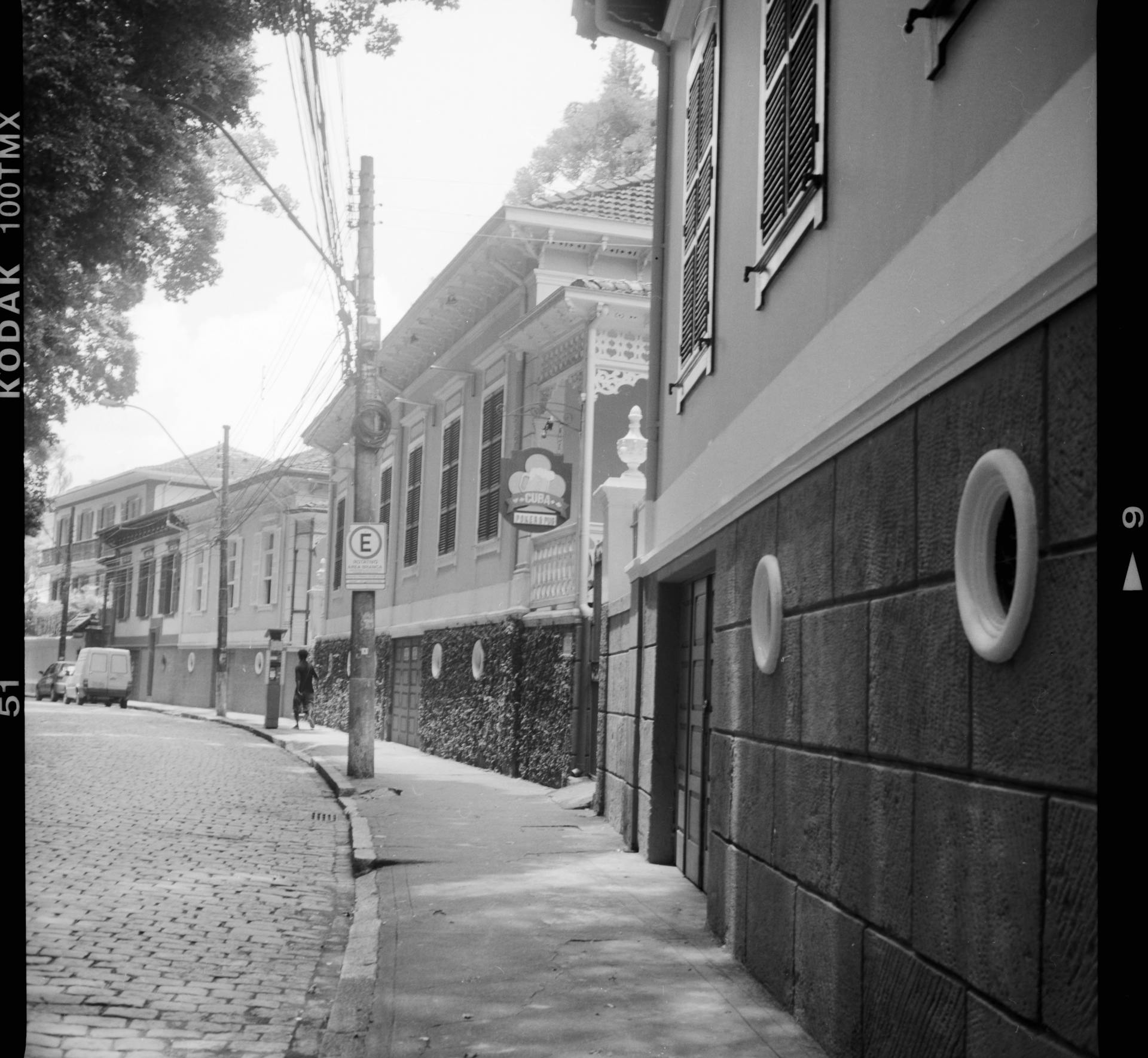 Black and white of ornamental Russian architecture buildings alongside empty pavement in old city