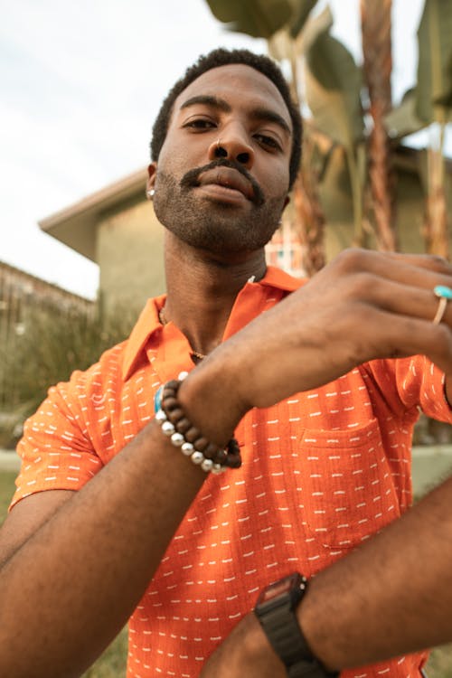 Free A Portrait of a Man in an Orange Shirt Stock Photo