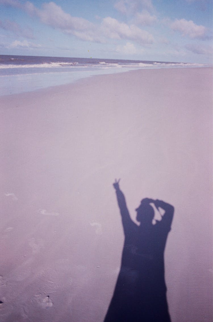 Silhouette Of Person On Sandy Beach