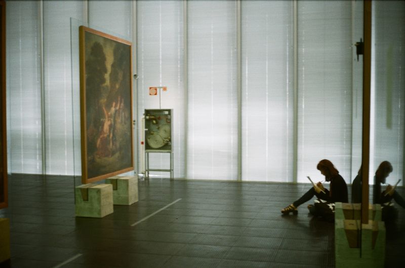 Visitor viewing a painting in a museum