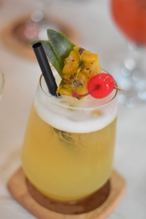 Free Close-up of a tropical cocktail with fruit garnishes, perfect for summer. Stock Photo