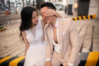 阳光明媚的日子里，一对快乐的亚洲新婚夫妇在户外一起欢笑