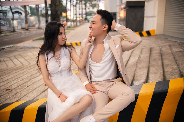 A Bride Holding A Smiling Groom's Chin