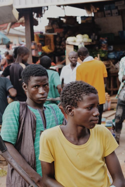 Free Thoughtful African American male adolescents in casual clothing in outside market in daytime Stock Photo