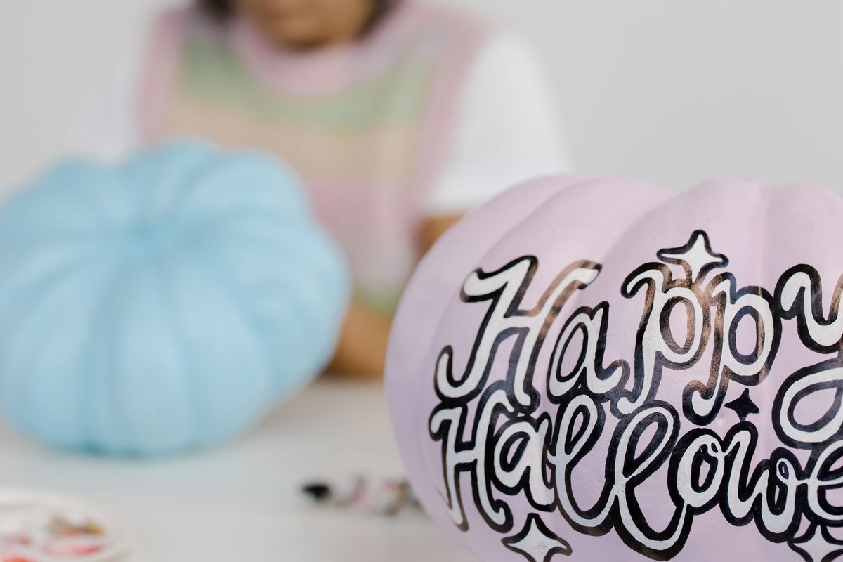 Close-up of decorated Halloween pumpkins with 'Happy Halloween' text. Vibrant, creative, and festive. Stock Photo.