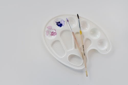 A Palette with Paint on a White Surface