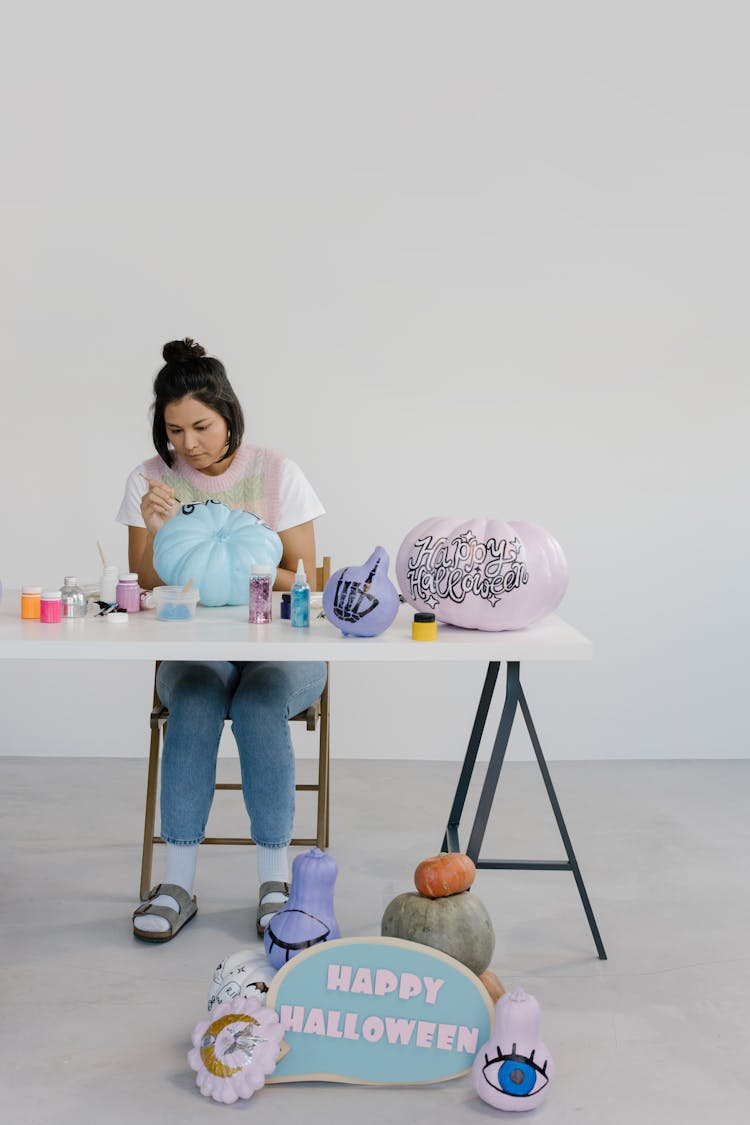 A Woman Painting Pumpkins 